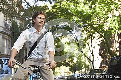 Businessman Riding Bicycle On City Street