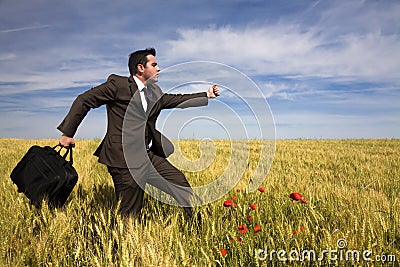 Businessman running in a field