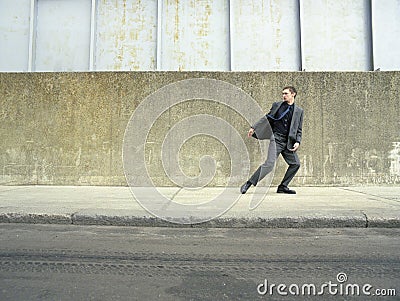 Businessman Running On Sidewalk