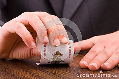 Businessman showing joker card.