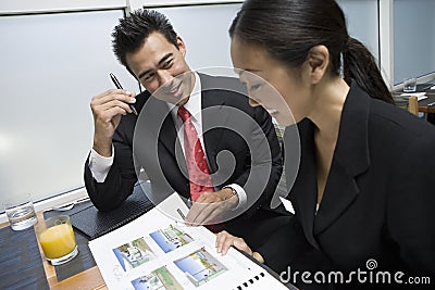 Businessman Showing Property Samples To His Business Partner