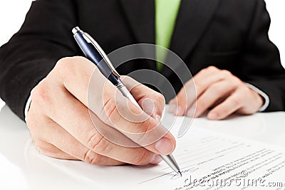 Businessman signing a document.