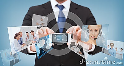 Businessman with smartphone and news on screen