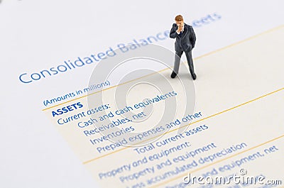 Businessman stand on the balance sheet