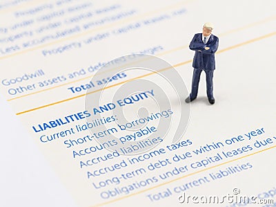 Businessman stand on the balance sheet