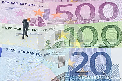Businessman standing on the Euro banknote