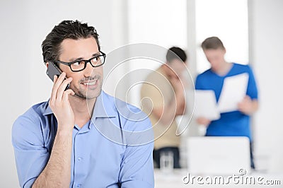 Businessman talking on the phone. Confident young businessman ta