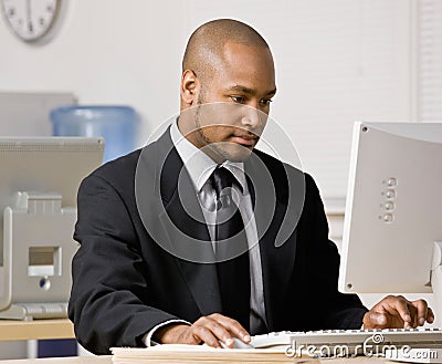 Businessman typing on computer at desk