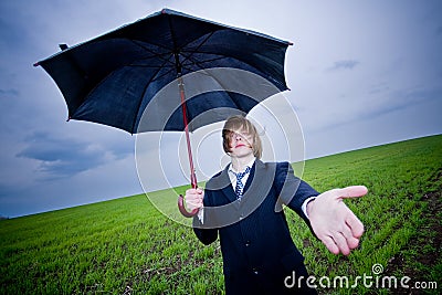 Businessman with umbrella outstretching hand