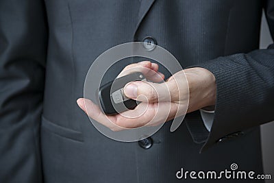 Businessman using car key