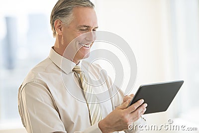 Businessman Using Digital Tablet In Office