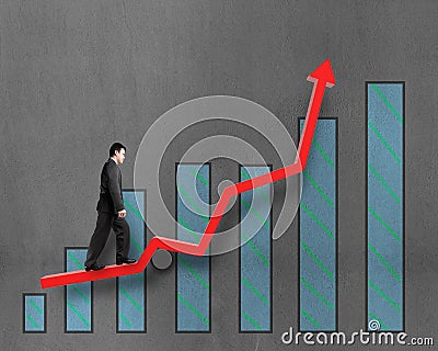 Businessman walking on growth red arrow with chart