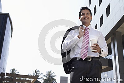 Businessman Walking With Takeaway Coffee Cup Outdoors