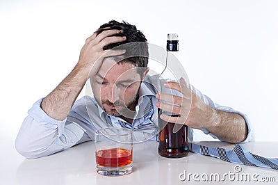 Businessman wearing blue shirt drunk at desk on white background