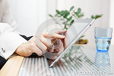 Businessman and woman pointing on digital tablet