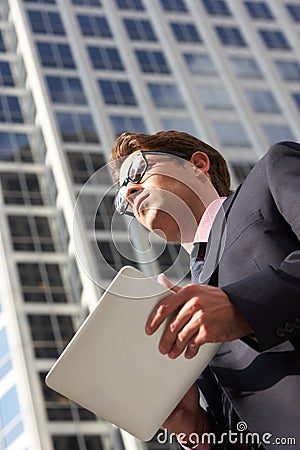 Businessman Working On Tablet Computer Outside Office