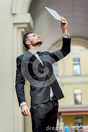 Businessman working on the tablet. Young man in formal wear fron