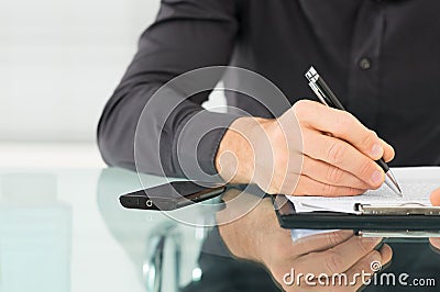 Businessman Writing a Paperwork