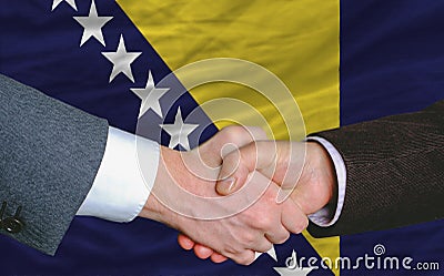 Businessmen handshake after good deal in front of bosnia herzego