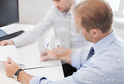 Businessmen with notebook on meeting