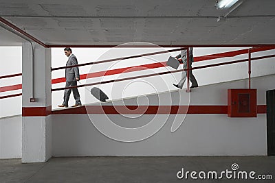 Businessmen Walking Down Ramp With Luggage In Parking Garage