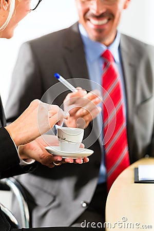 Businesspeople in business office drink coffee