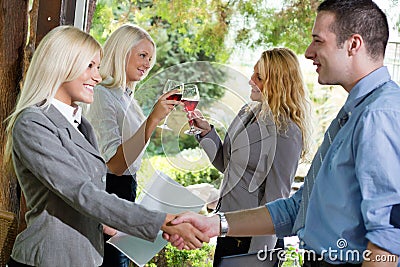 Businesspeople shaking hands in restaurant,focus on the last tw