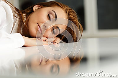 Businesswoman fallen asleep at office table