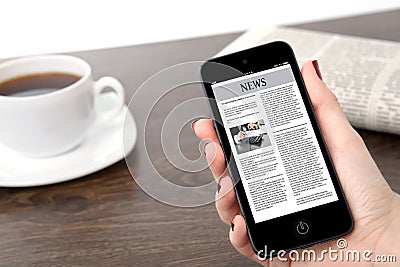 Businesswoman hand holding a phone with business news against th