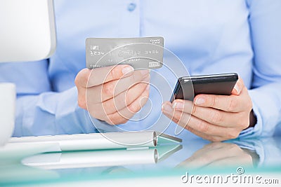 Businesswoman holding cellphone and credit card