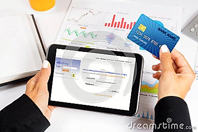 Businesswoman holding credit card and tablet - e banking / shopping online.