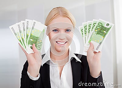 Businesswoman holding euro currency notes