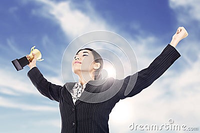 Businesswoman holding a trophy