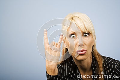 Businesswoman making bull horns