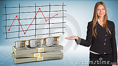 Businesswoman points hand on houses and money