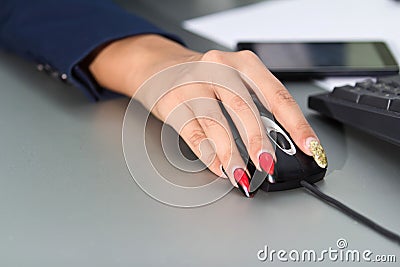 Businesswoman s hand on mouse
