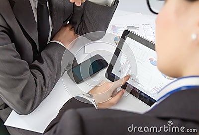 Businesswoman showing documents in digital tablet