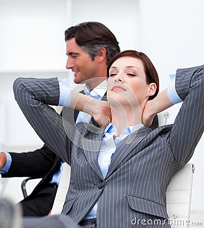 Businesswoman sleeping with feet on desk