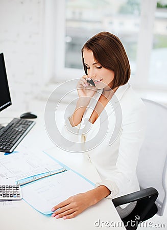 Businesswoman with smartphone in office