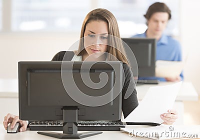 Businesswoman Using Desktop Pc At Desk