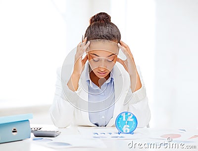 Businesswoman working with calculator in office