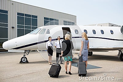 Businesswomen Walking Towards Private Jet