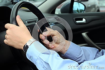 Businwssman using mobile phone while driving the car