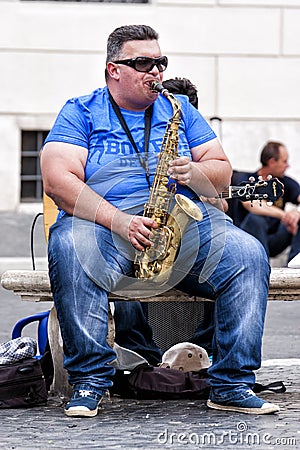 Fat busker playing sax seated on a bench