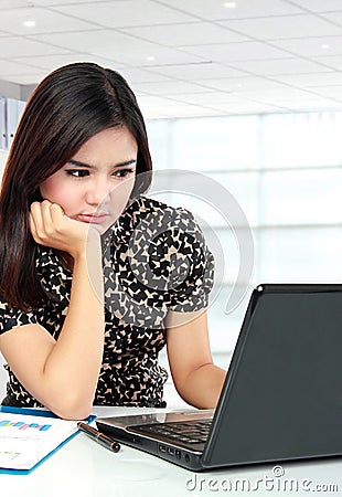 Busy business woman working with laptop at her office