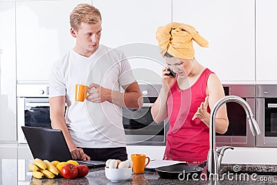 Busy couple in the morning in kitchen