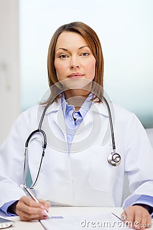 Busy doctor with laptop computer and clipboard