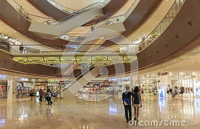People in busy shopping mall, interior of shopping mall, inside modern shopping center hall