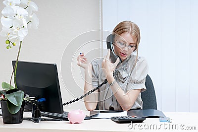 Busy office girl talking on mobile phone.