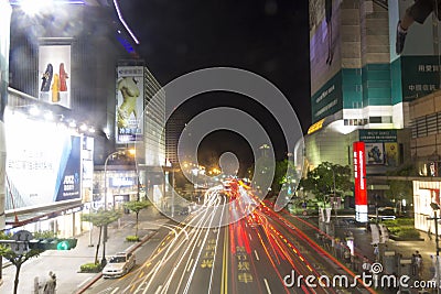 Busy Taipei street in the night with motion blured car lights